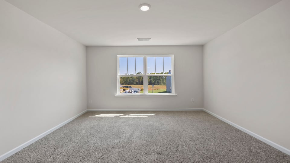 Bedroom with carpet and windows.
