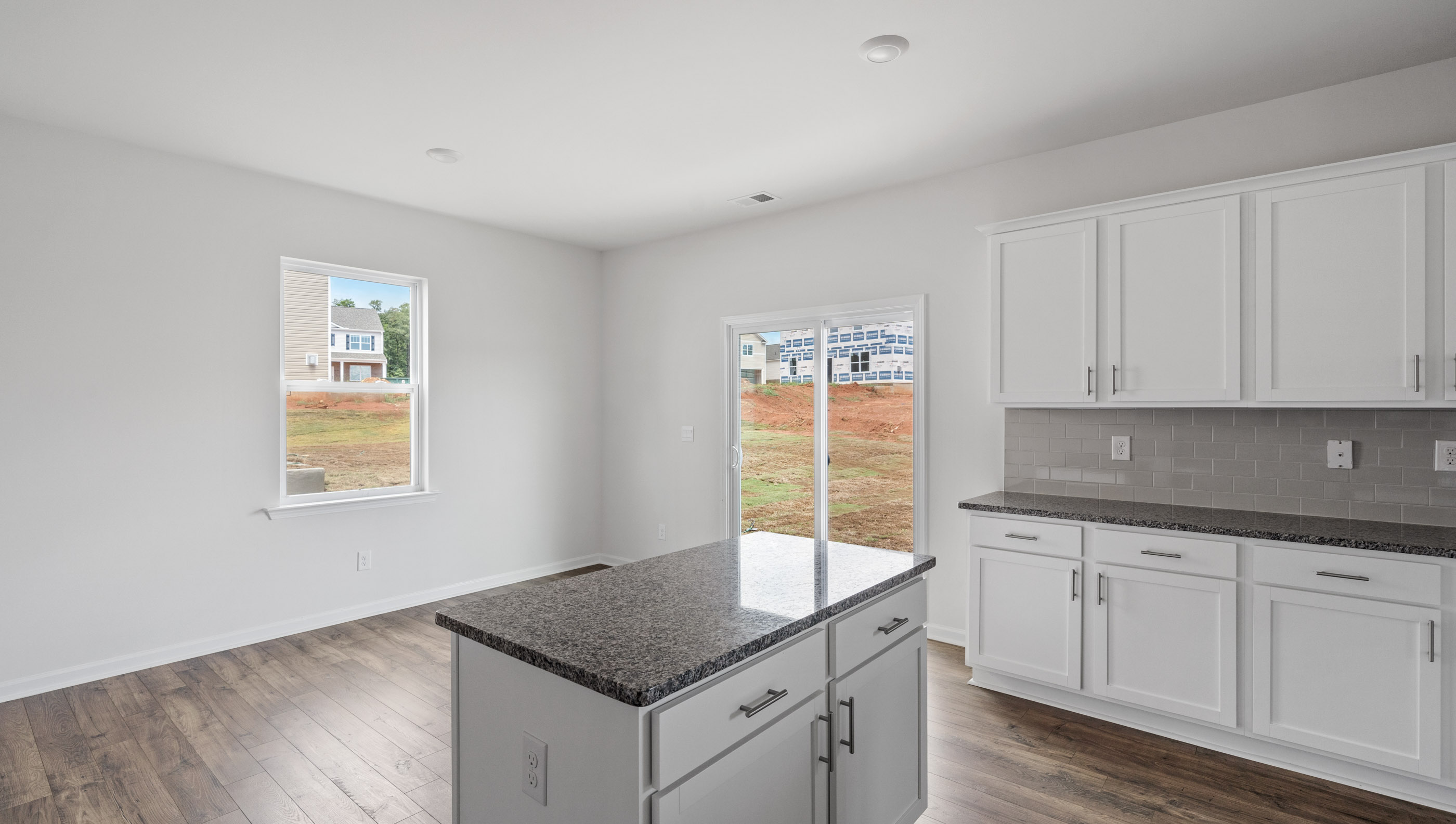 Kitchen and island with granite counter tops.