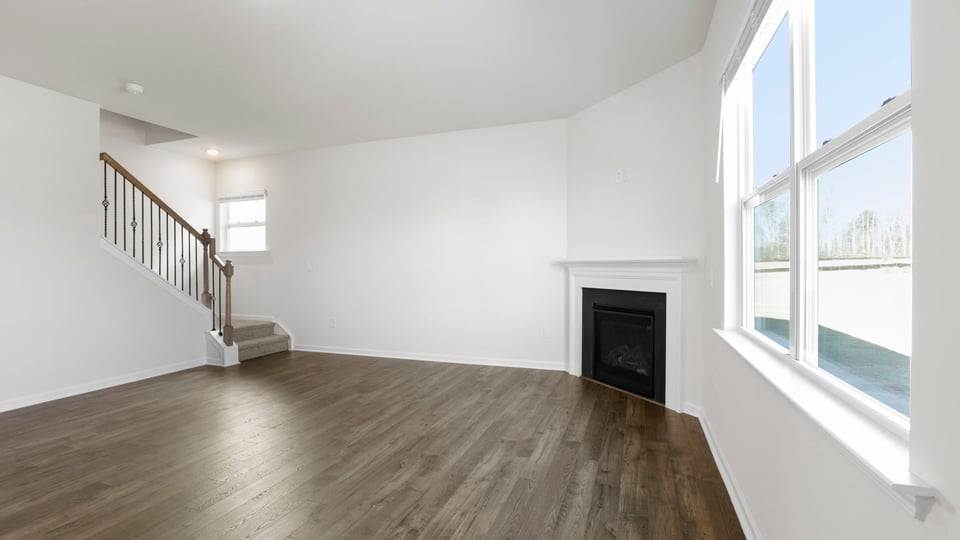 Living room with fireplace and window.