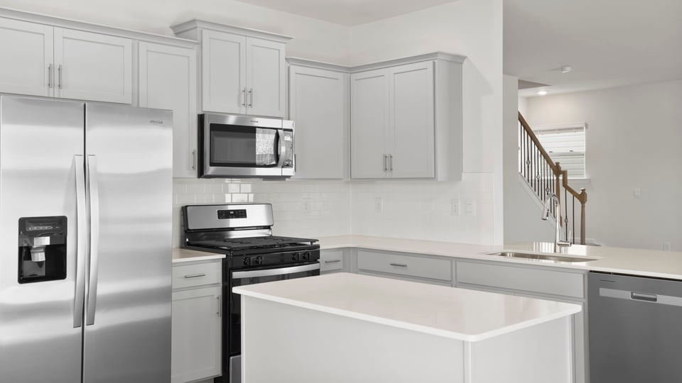 Kitchen and island with granite countertops.