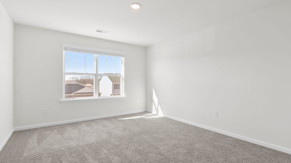 Bedroom with carpet and window.