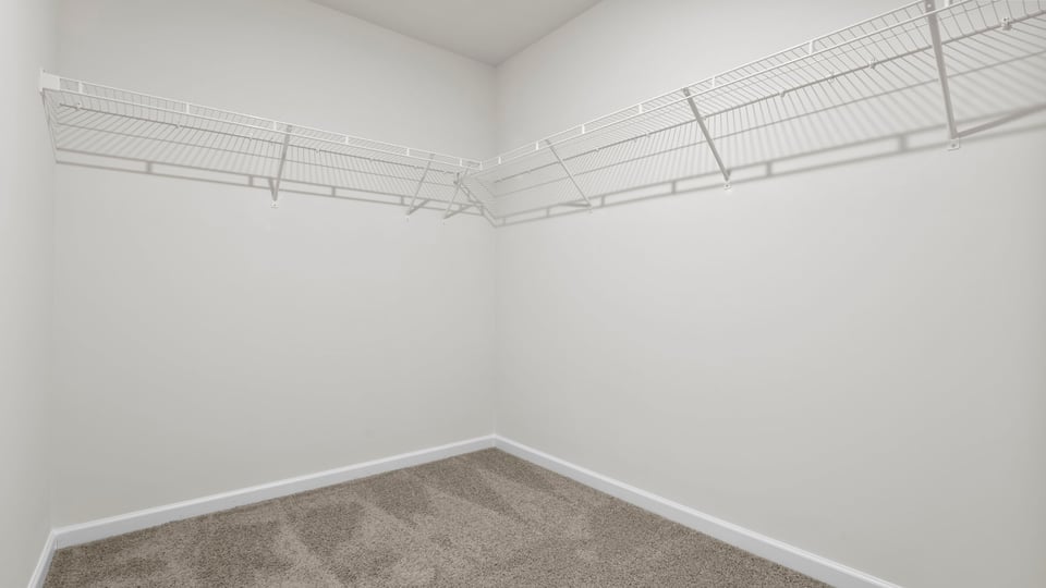 Walk in closet with shelves.