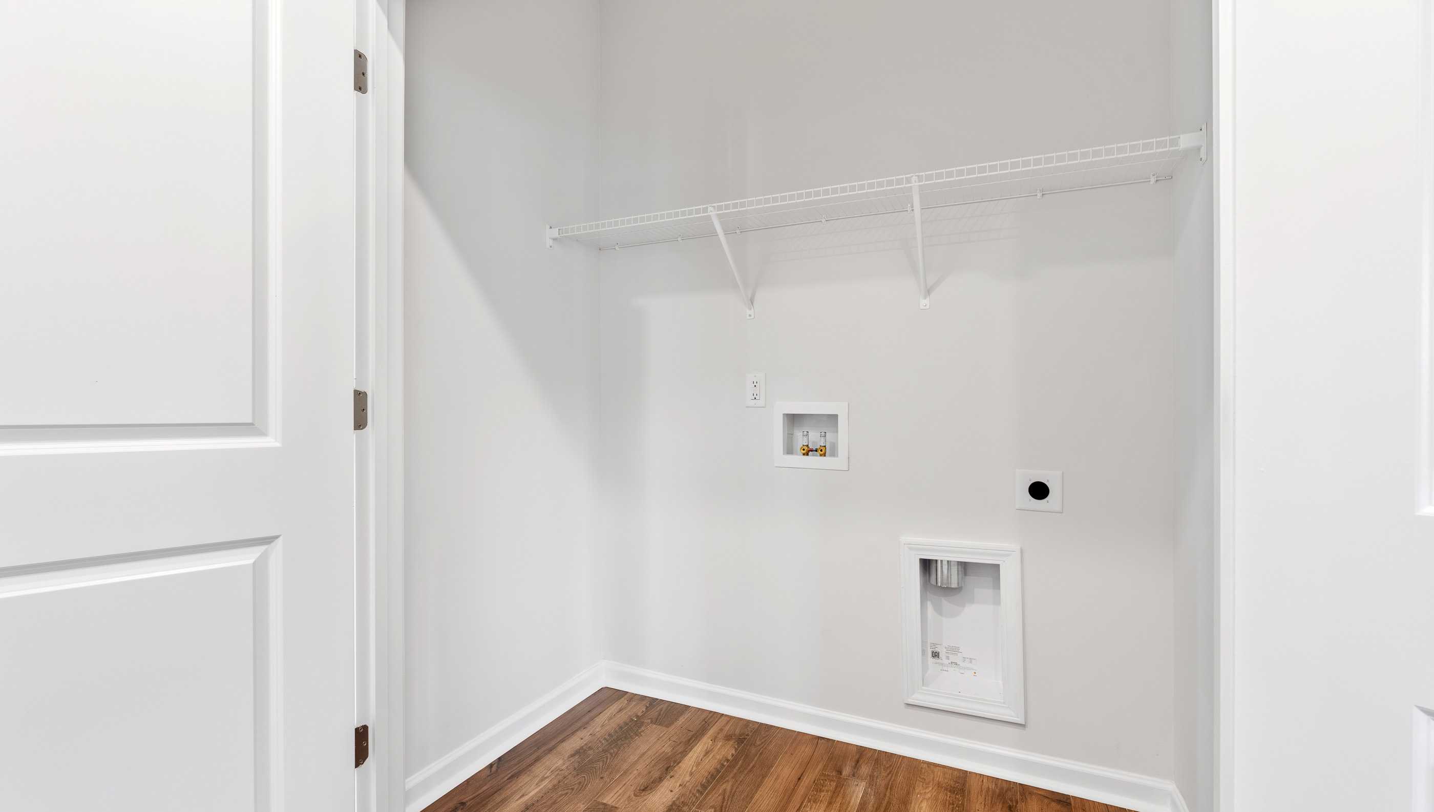 Walk in laundry with shelves.