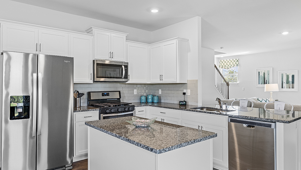 Kitchen and island with granite counter tops.