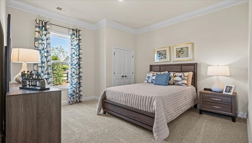 Bedroom with carpet and window.