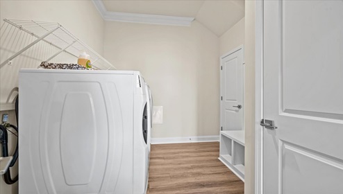 Laundry room with hanging storage racks.