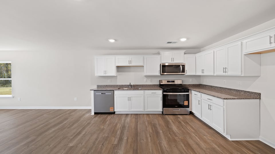 Open kitchen with quartz countertops.