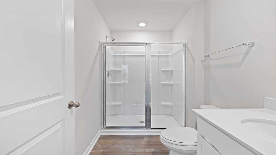 Primary bathroom with vanity and walk-in shower.