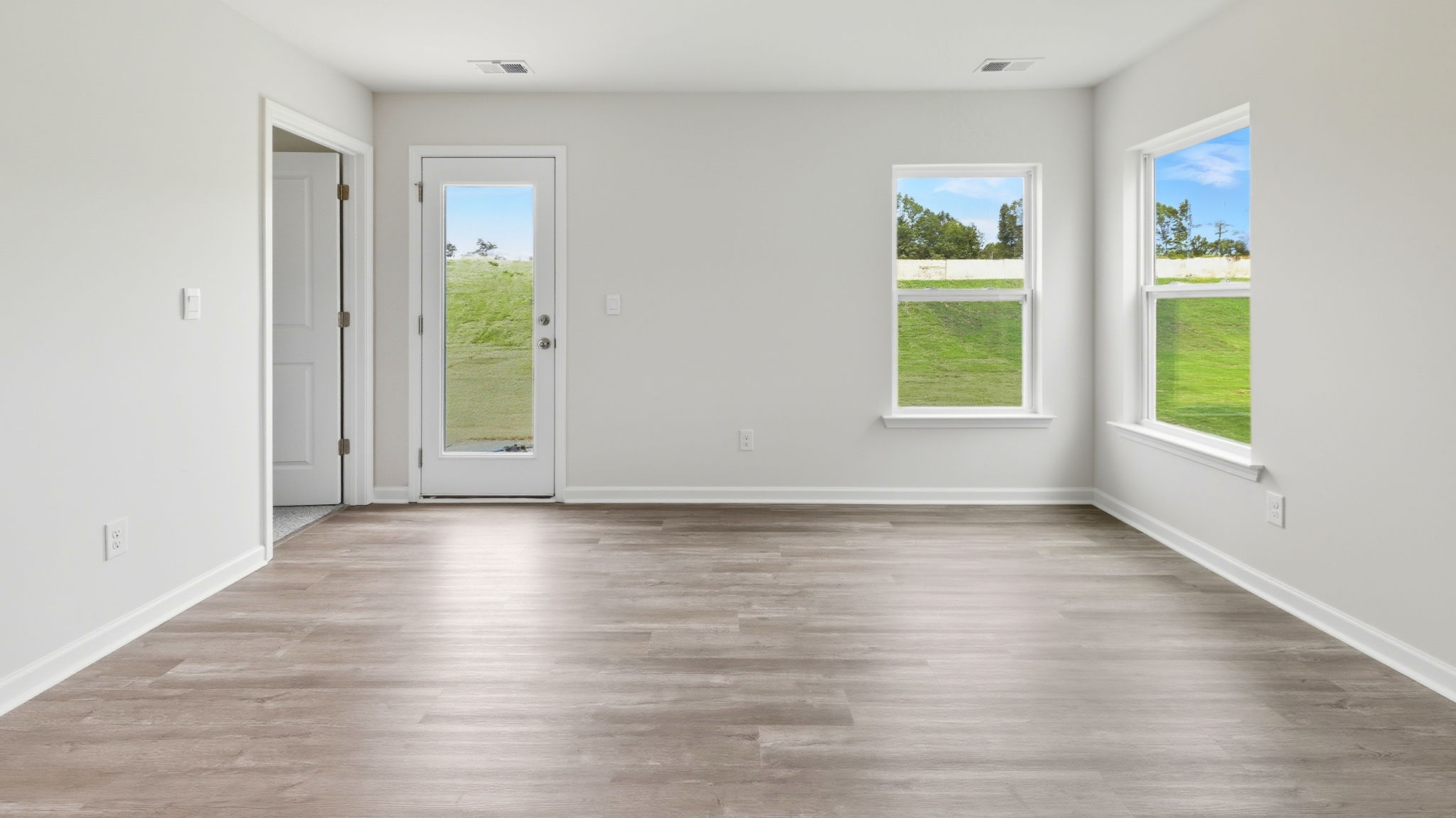 View of the family room with lots of windows and door to the back yard.