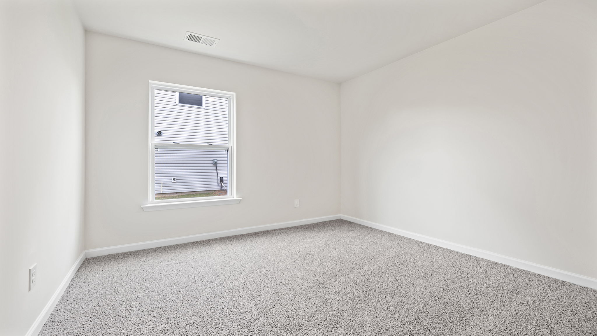 Bedroom with window and carpet.