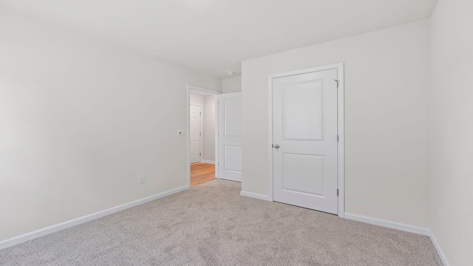 Bedroom with window and carpet.