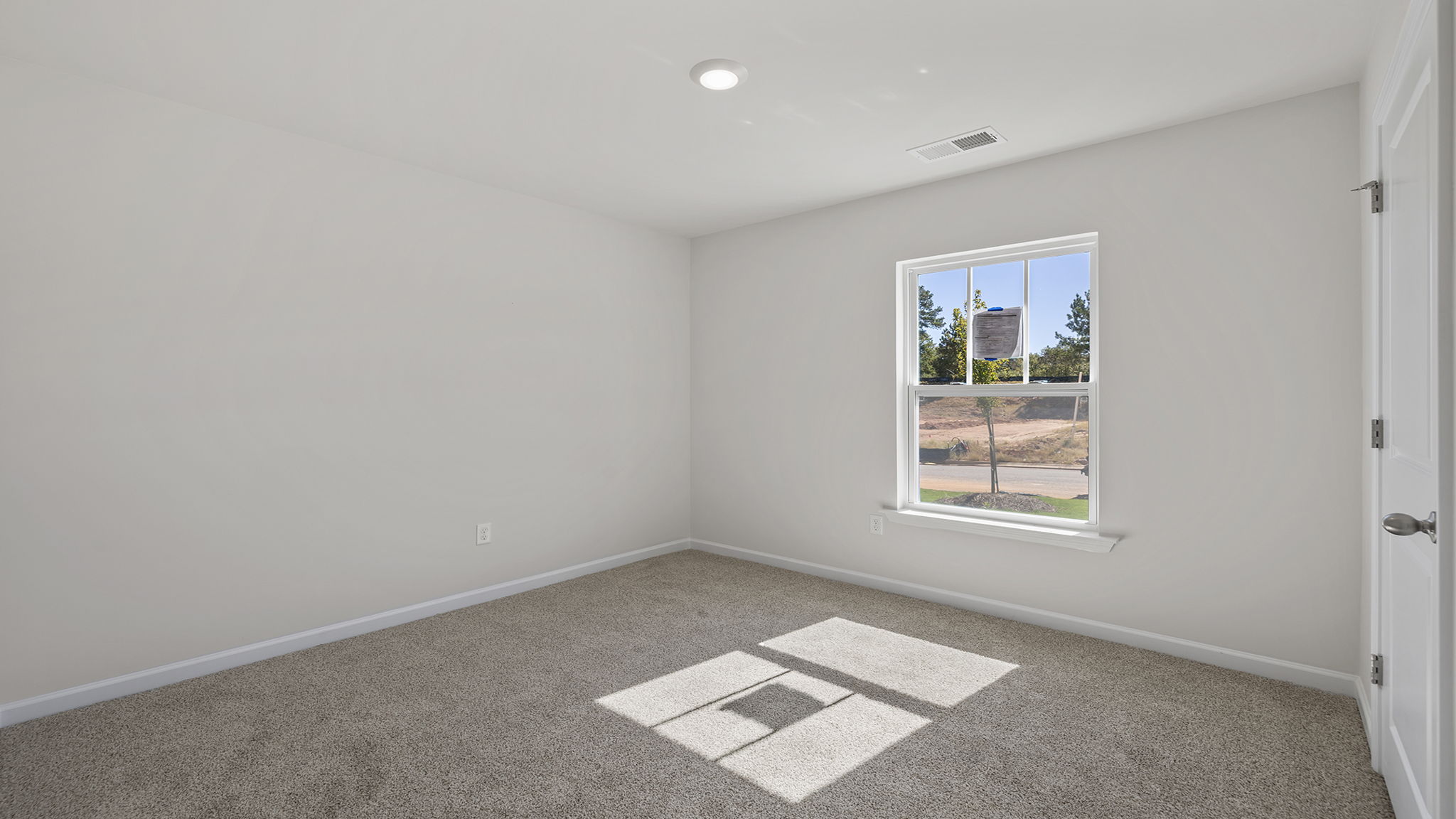 Bedroom with window and carpet.