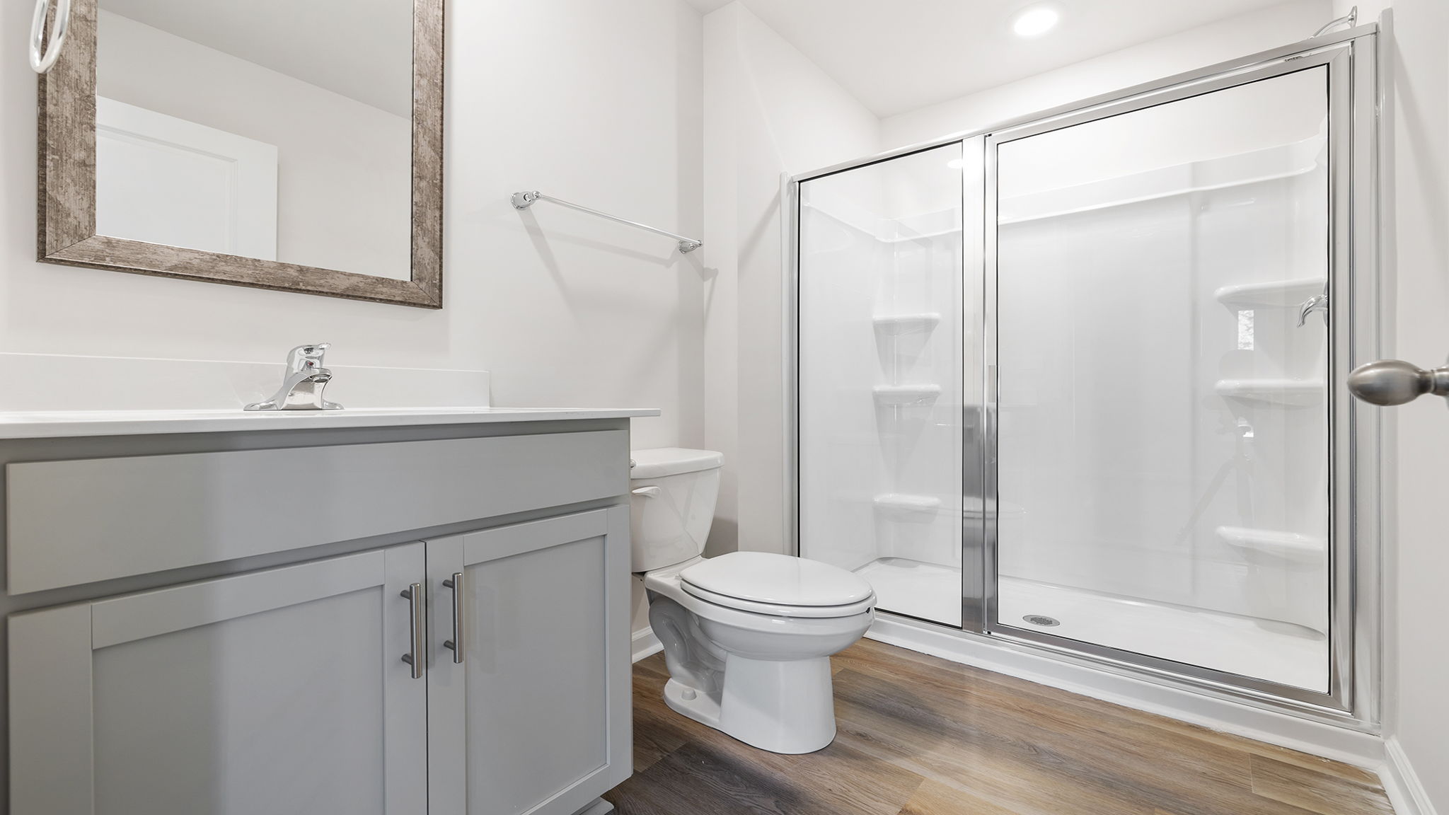 Primary bathroom with vanity and walk-in shower.