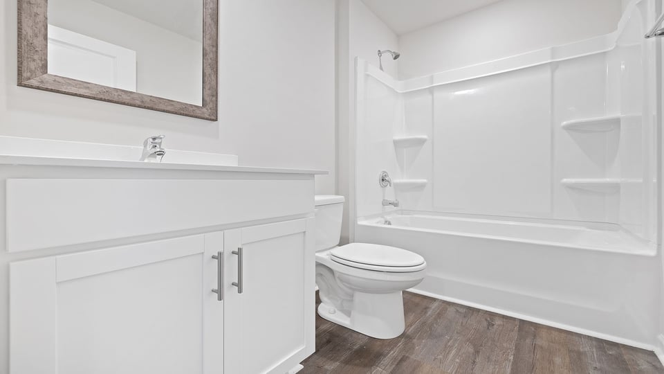 Hall bathroom with vanity and combination shower / tub.