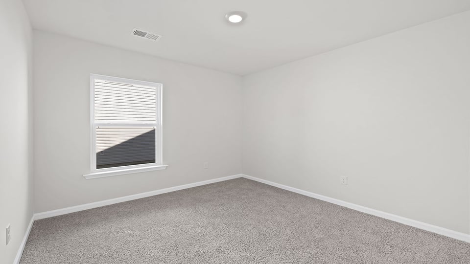 Bedroom with window and carpet.