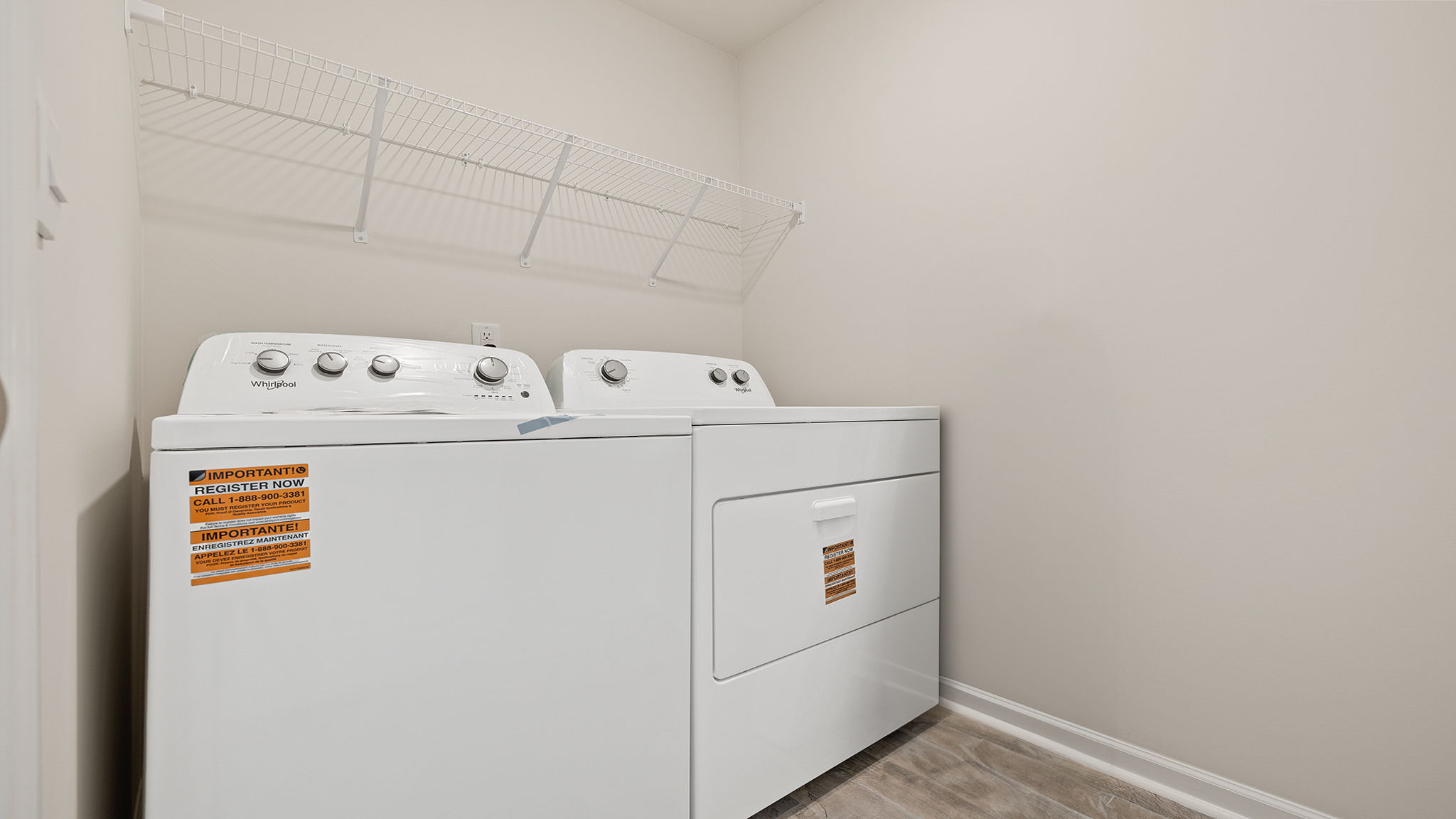 Walk-in laundry room with shelving.