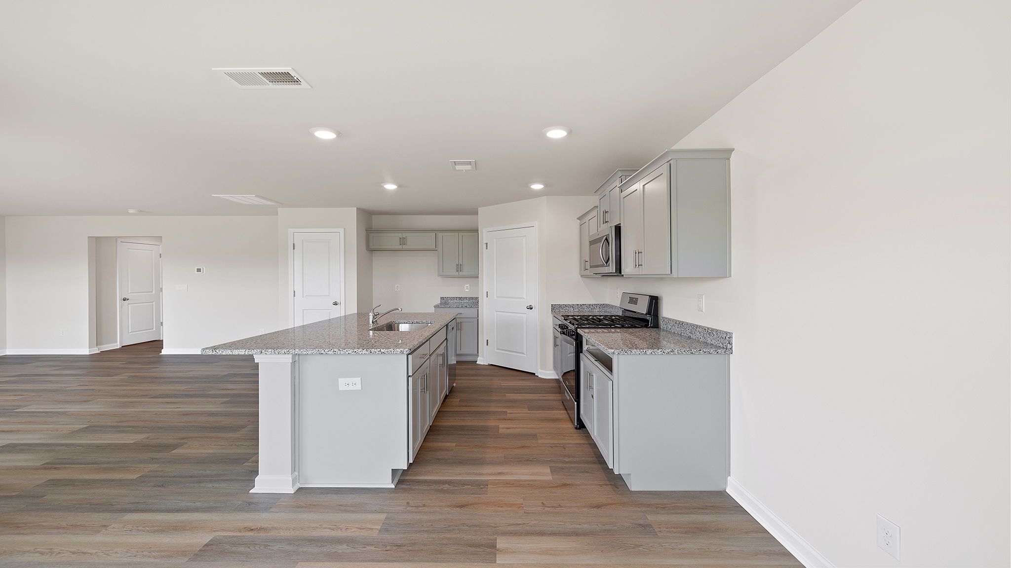 Kitchen and island have quartz countertops.