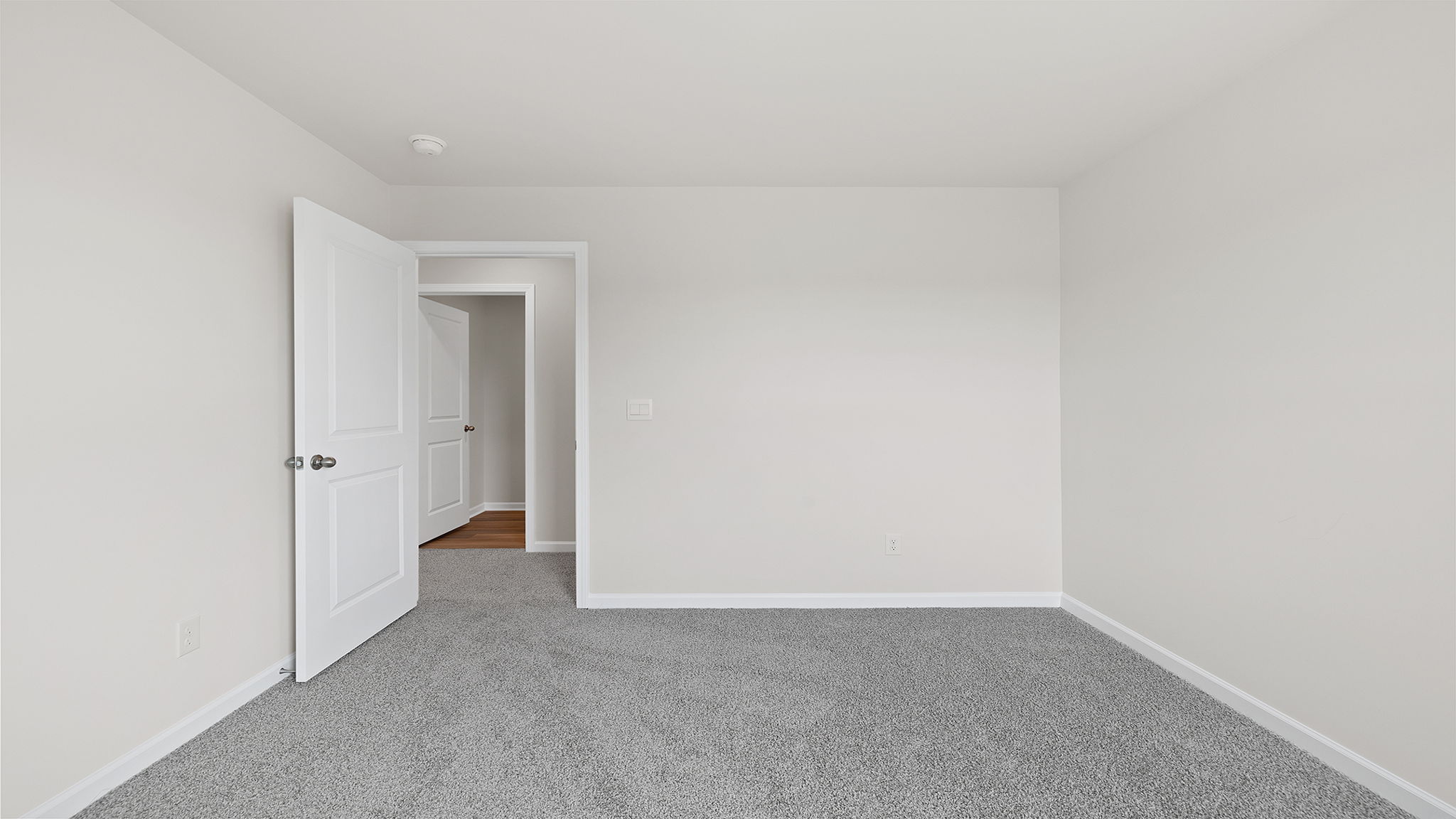 Bedroom with window and carpet.