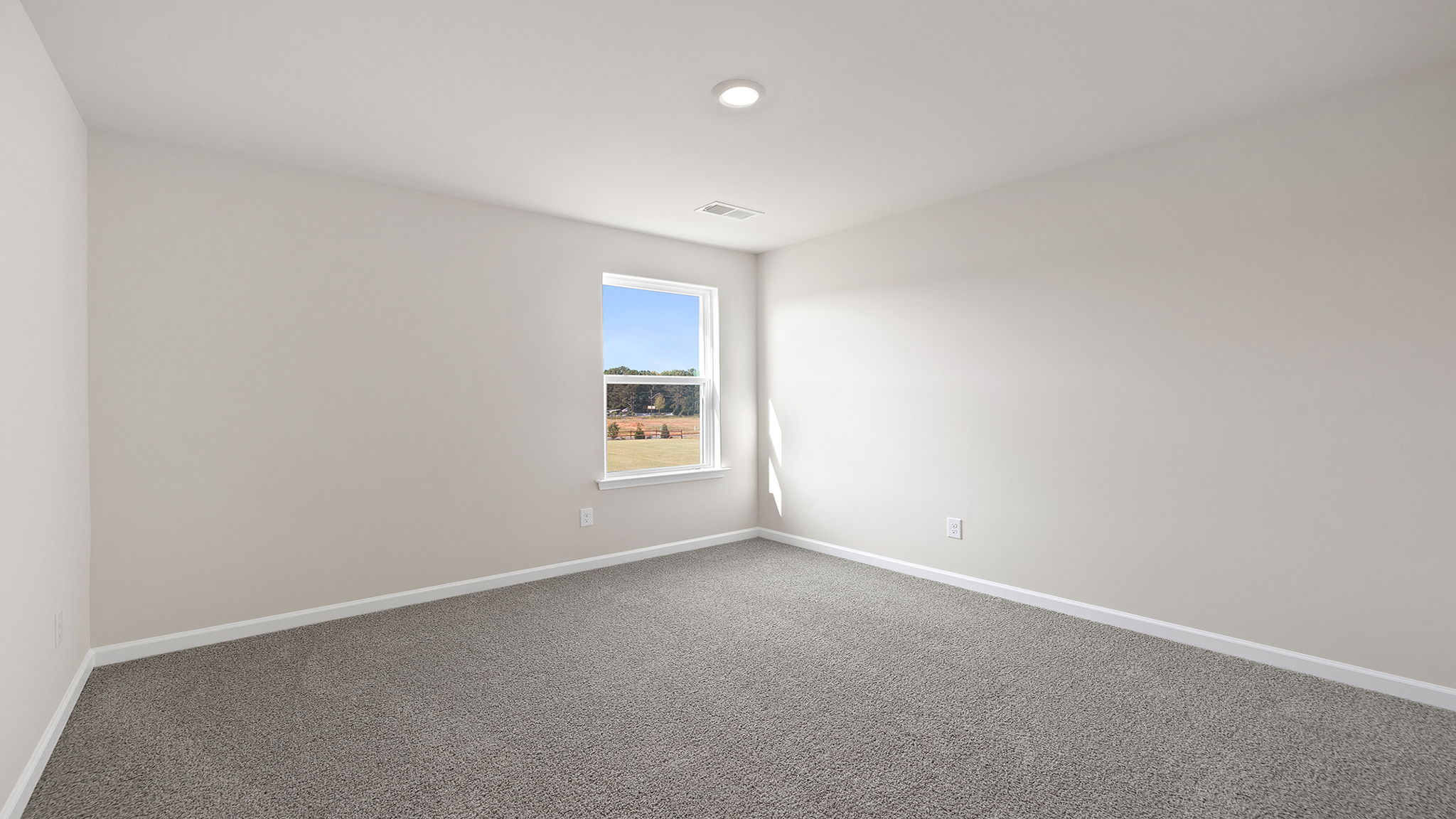 Bedroom with window and carpet.