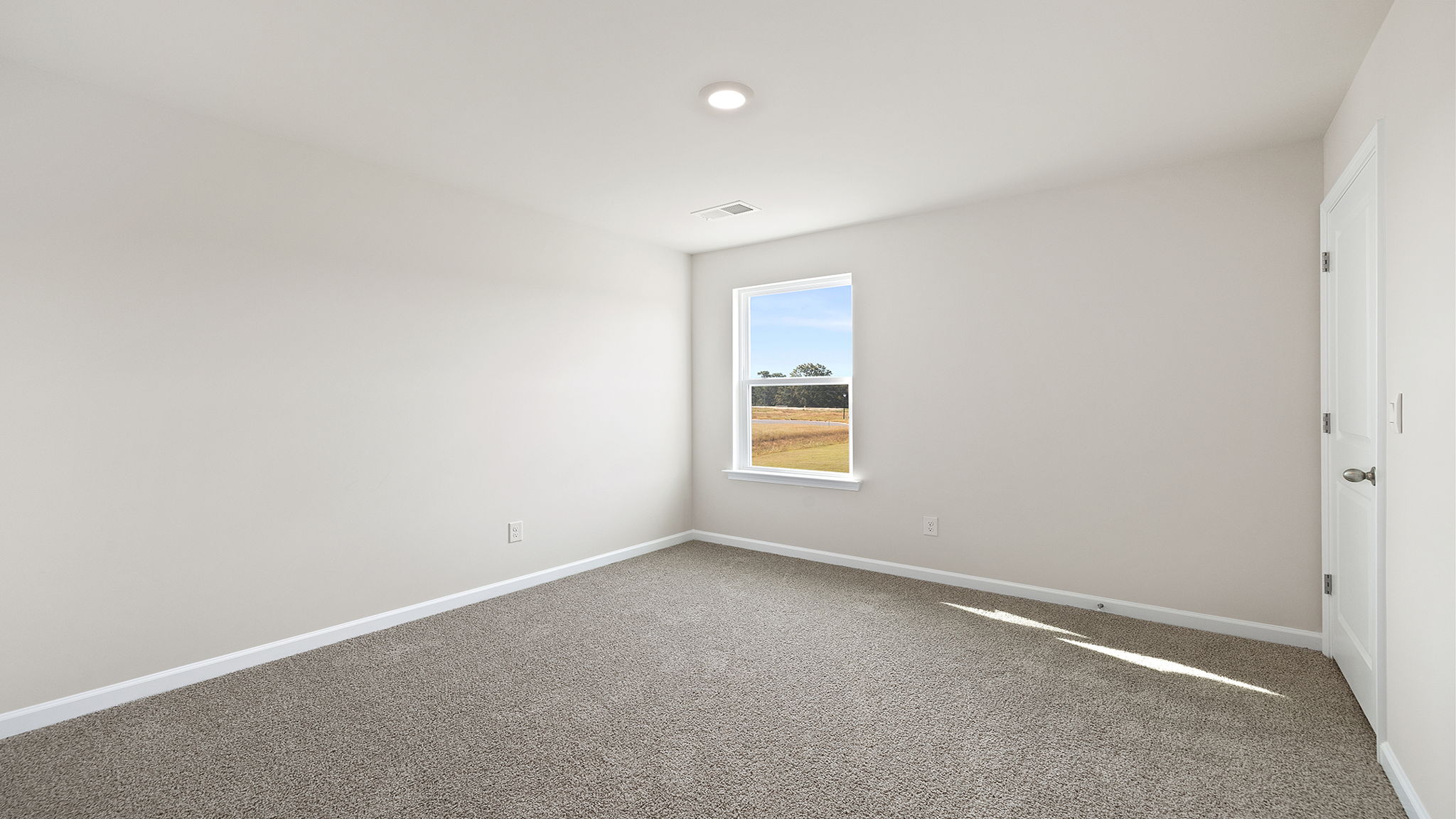 Bedroom with window and carpet.
