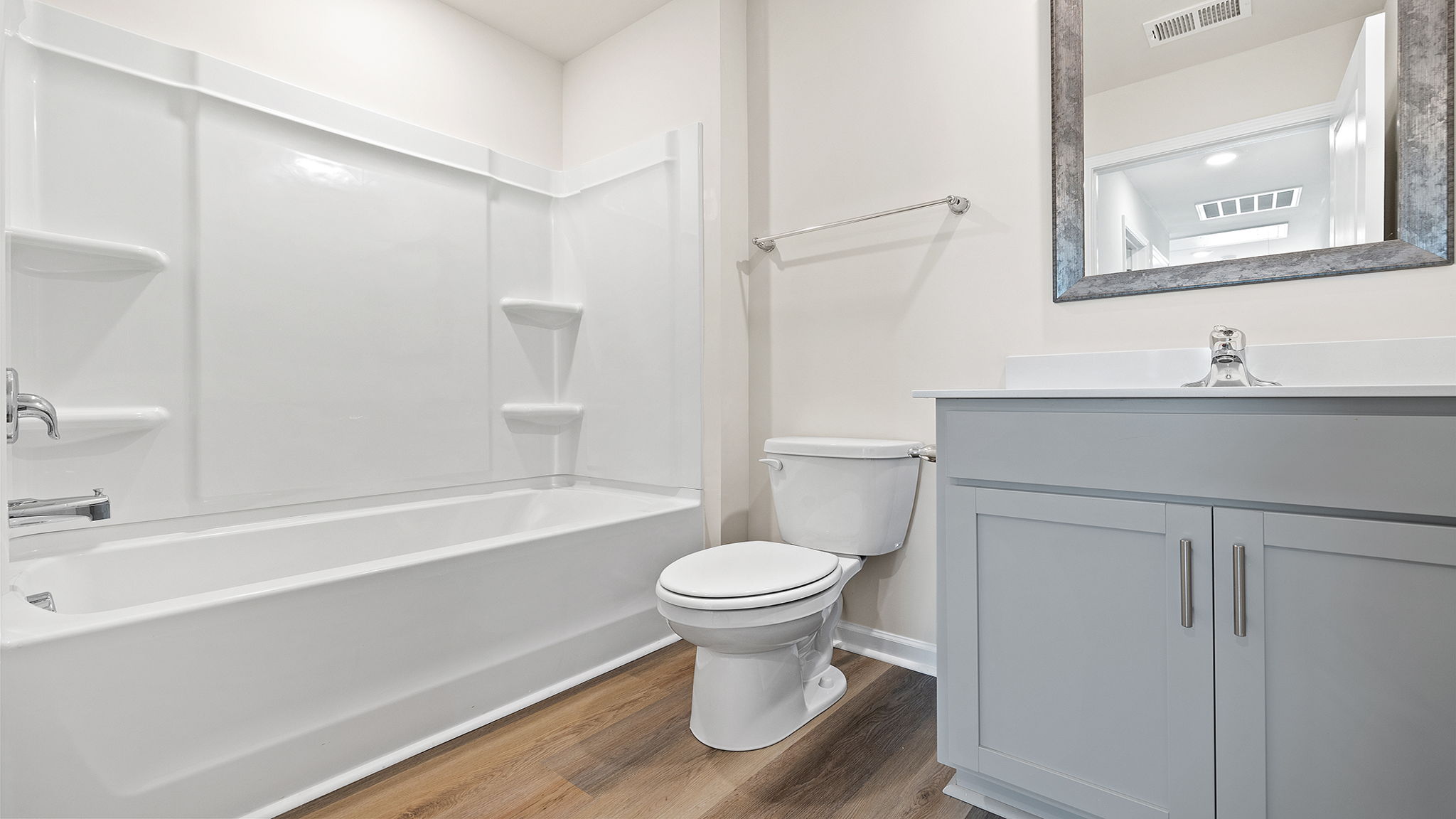 Hall bathroom with vanity and combination shower / tub.
