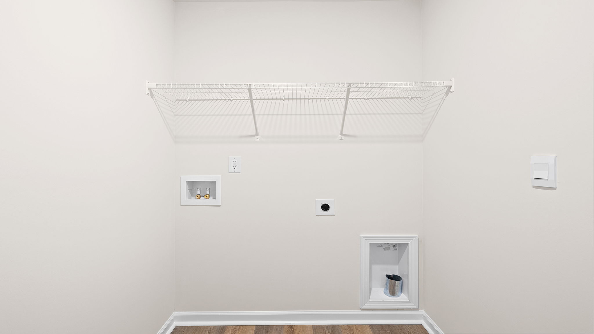Walk-in laundry room with shelving.