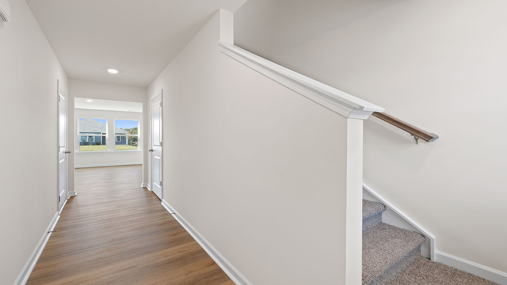 View of the stairwell and hallway into the family room.
