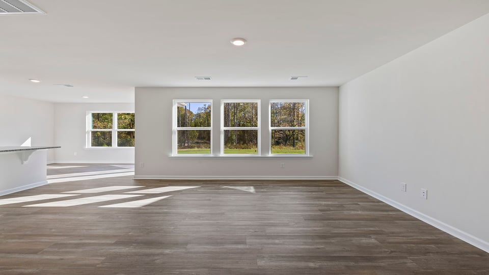 View of family room with three large windows.