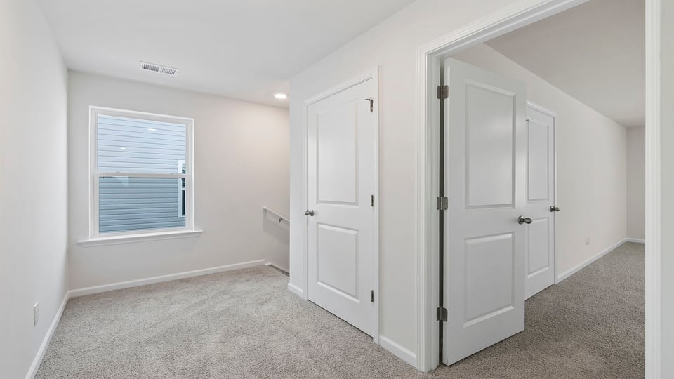 View of landing at top of the stairs and hallway to bedrooms.