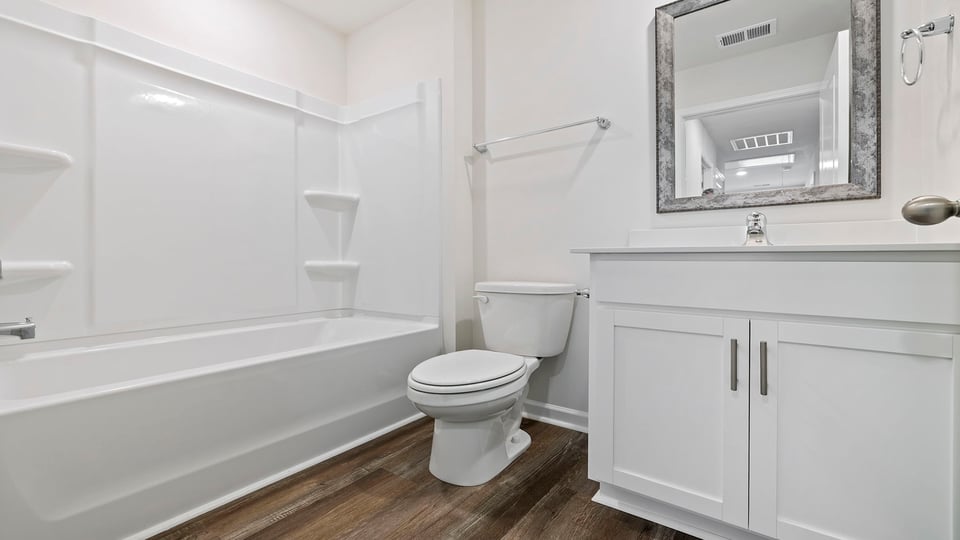 Hall bathroom with vanity and combination shower / tub.