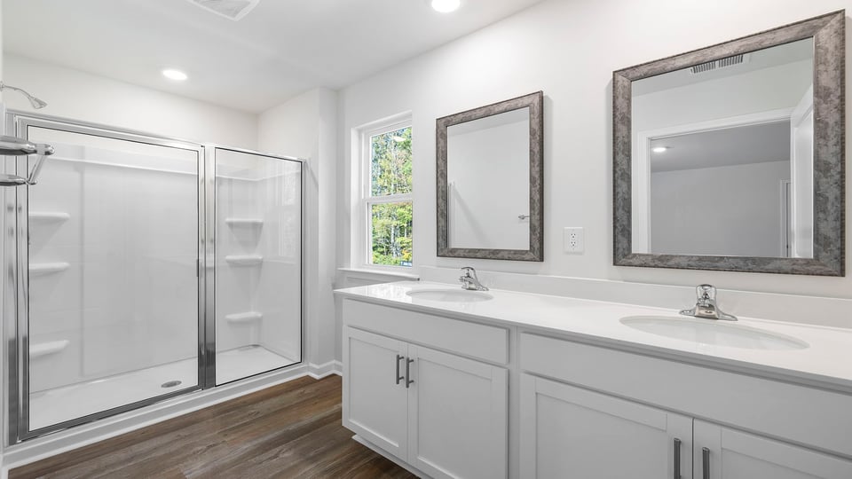 Primary bath with dual sink vanity and walk-in shower.