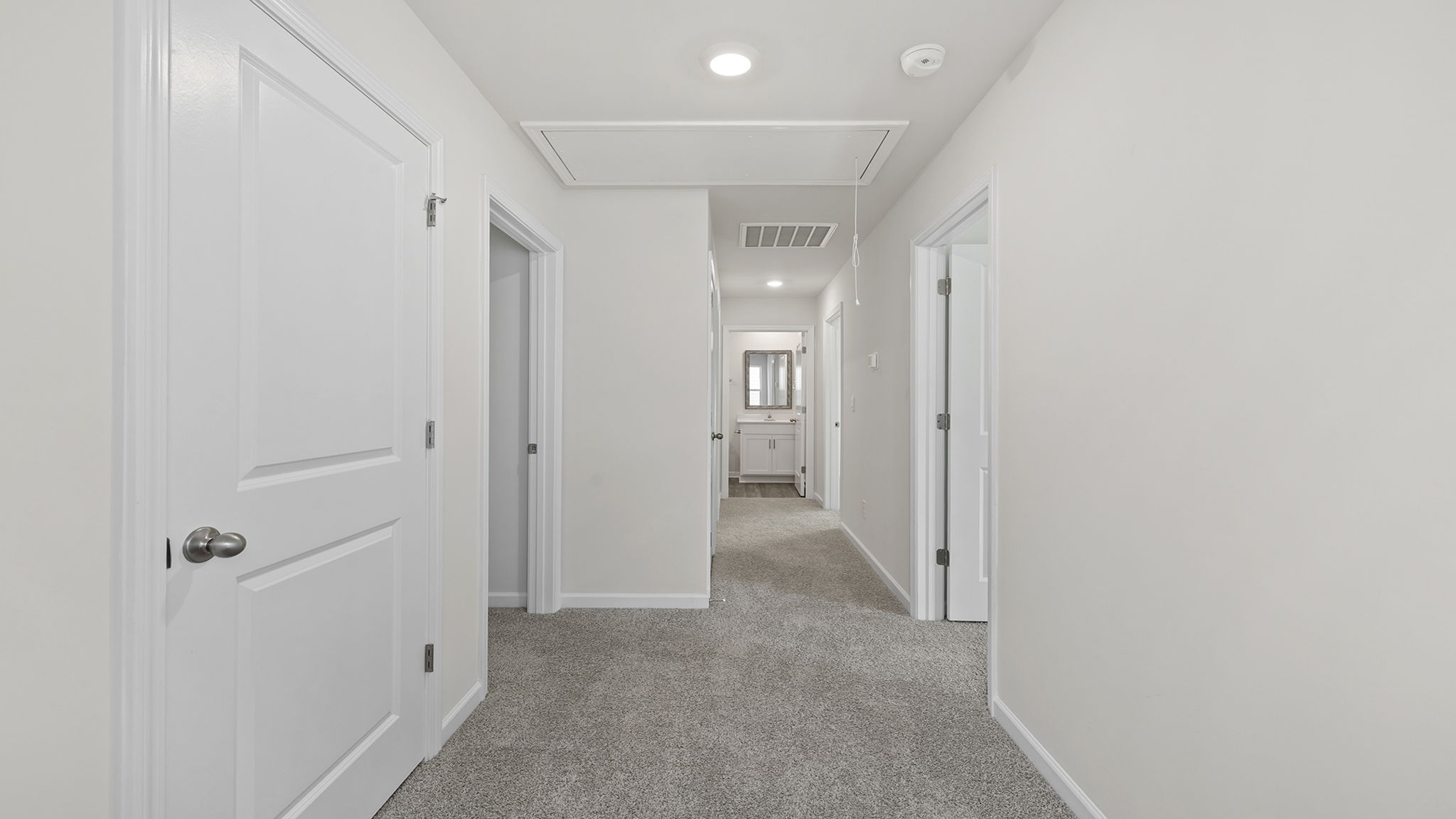 View of landing at top of the stairs and hallway to bedrooms.