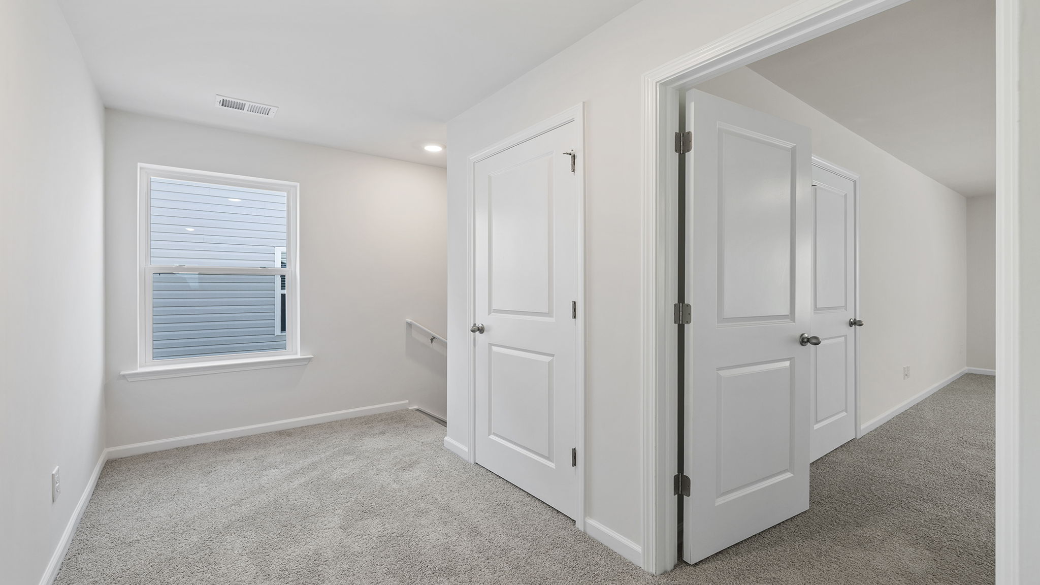 View of landing at top of the stairs and hallway to bedrooms.