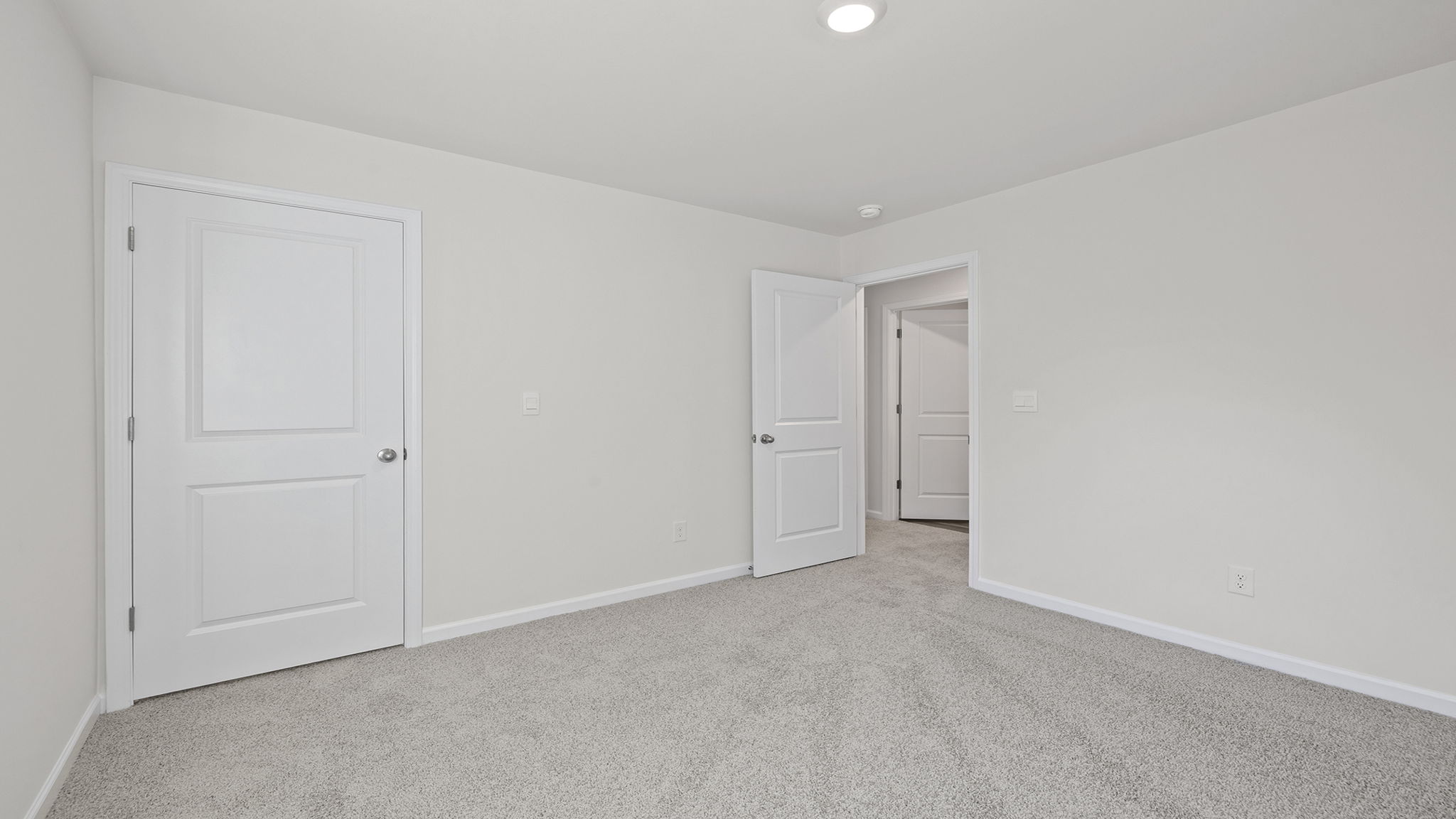 Bedroom with window and carpet.