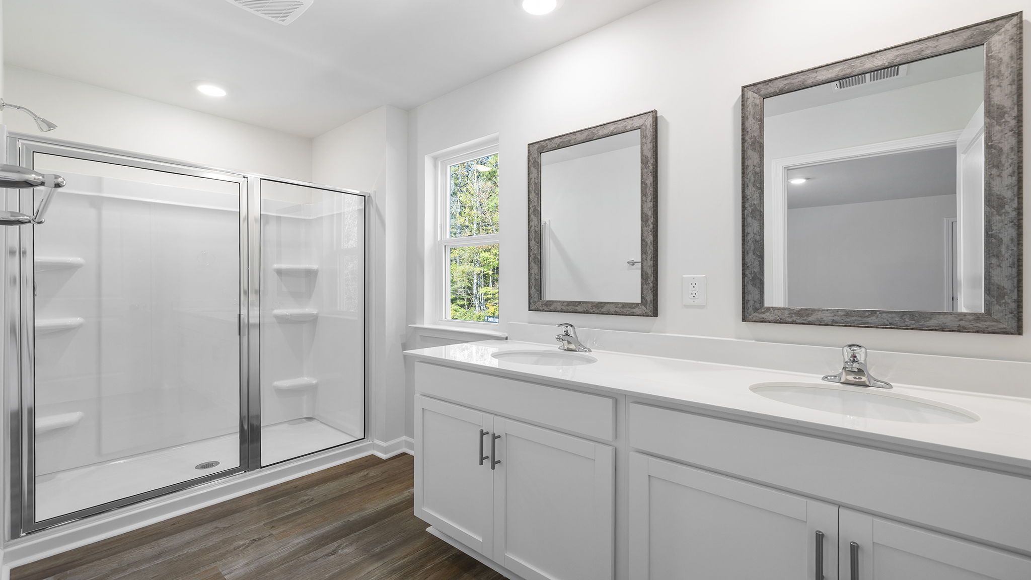 Primary bath with dual sink vanity and walk-in shower.