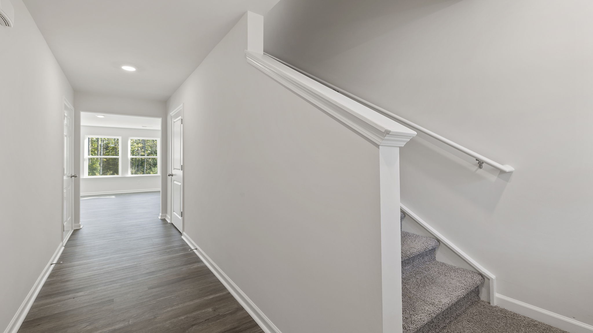 View of the stairwell and hallway into the family room.