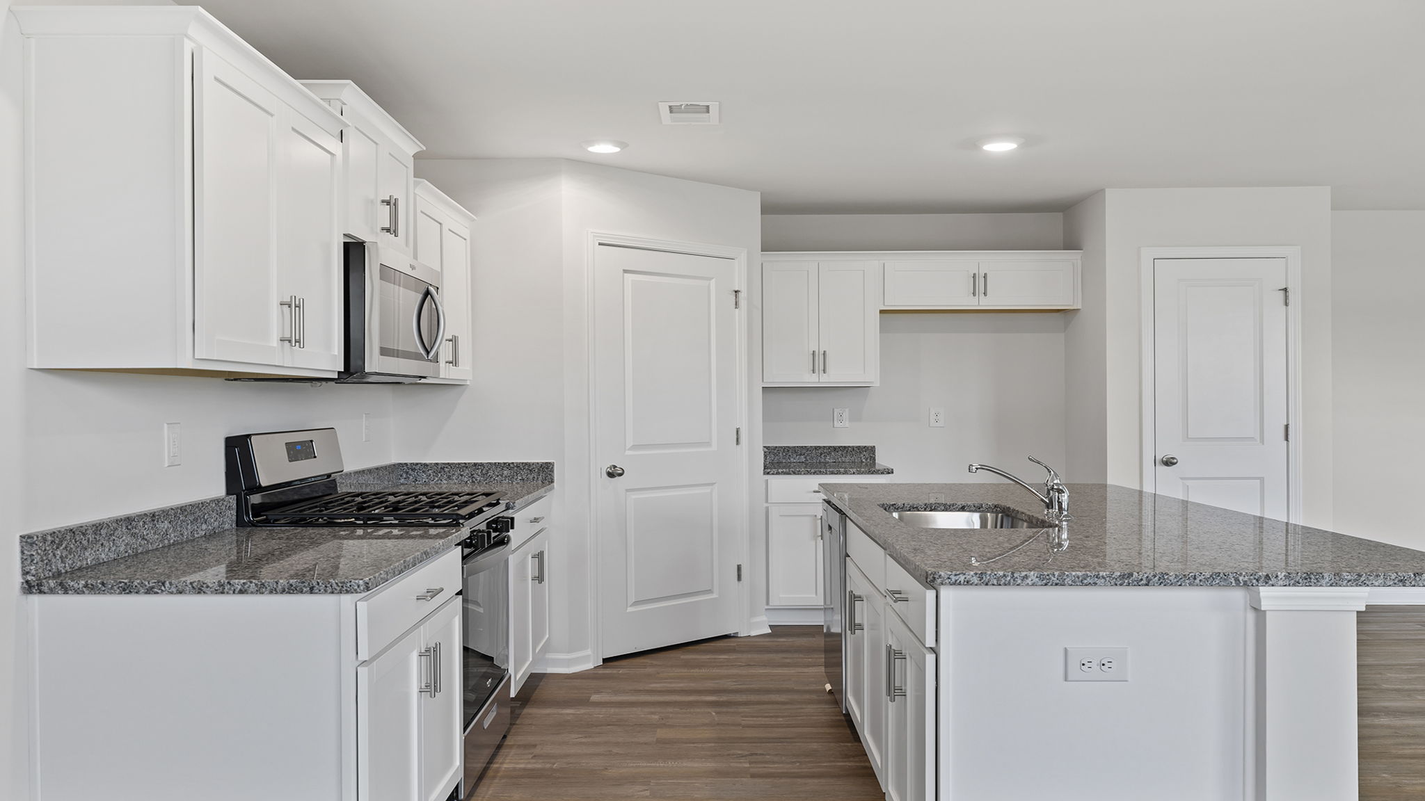 Kitchen with island and quartz countertops.