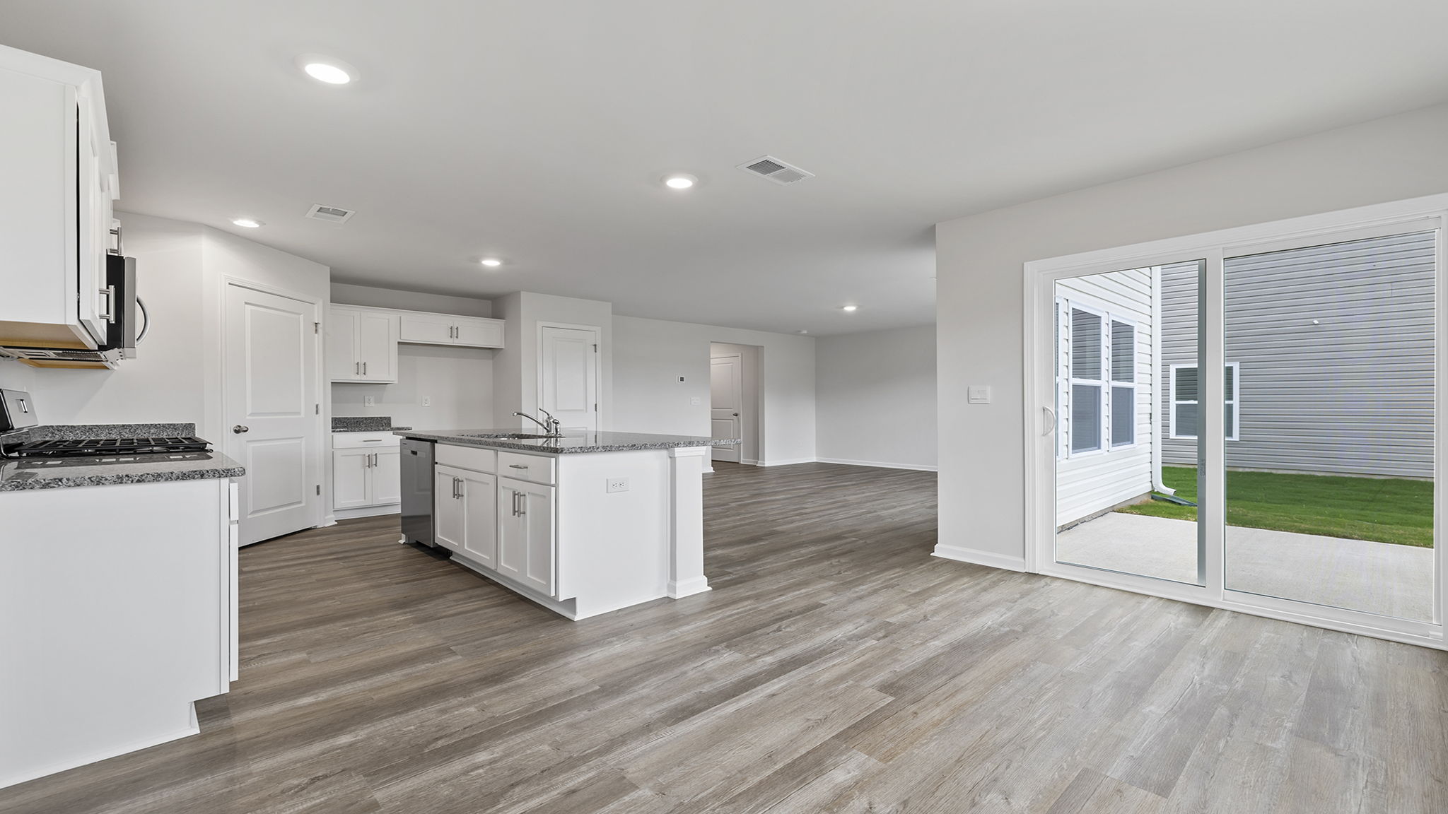 View of kitchen and doors to the back yard.
