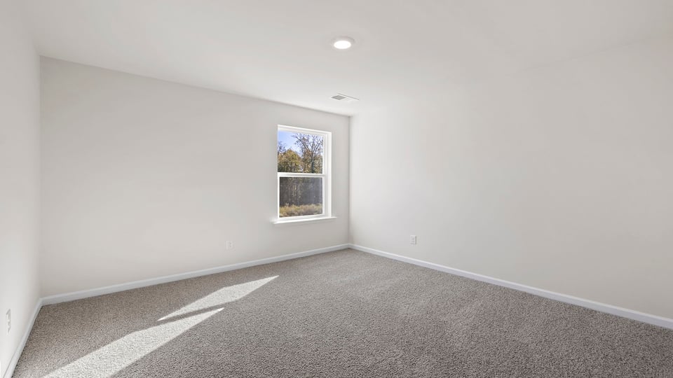 Bedroom with window and carpet.