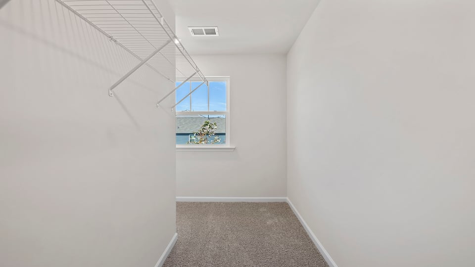 Primary bedroom walk-in closet.