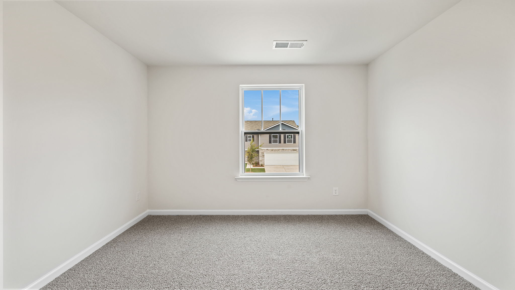 Bedroom with carpet and window.