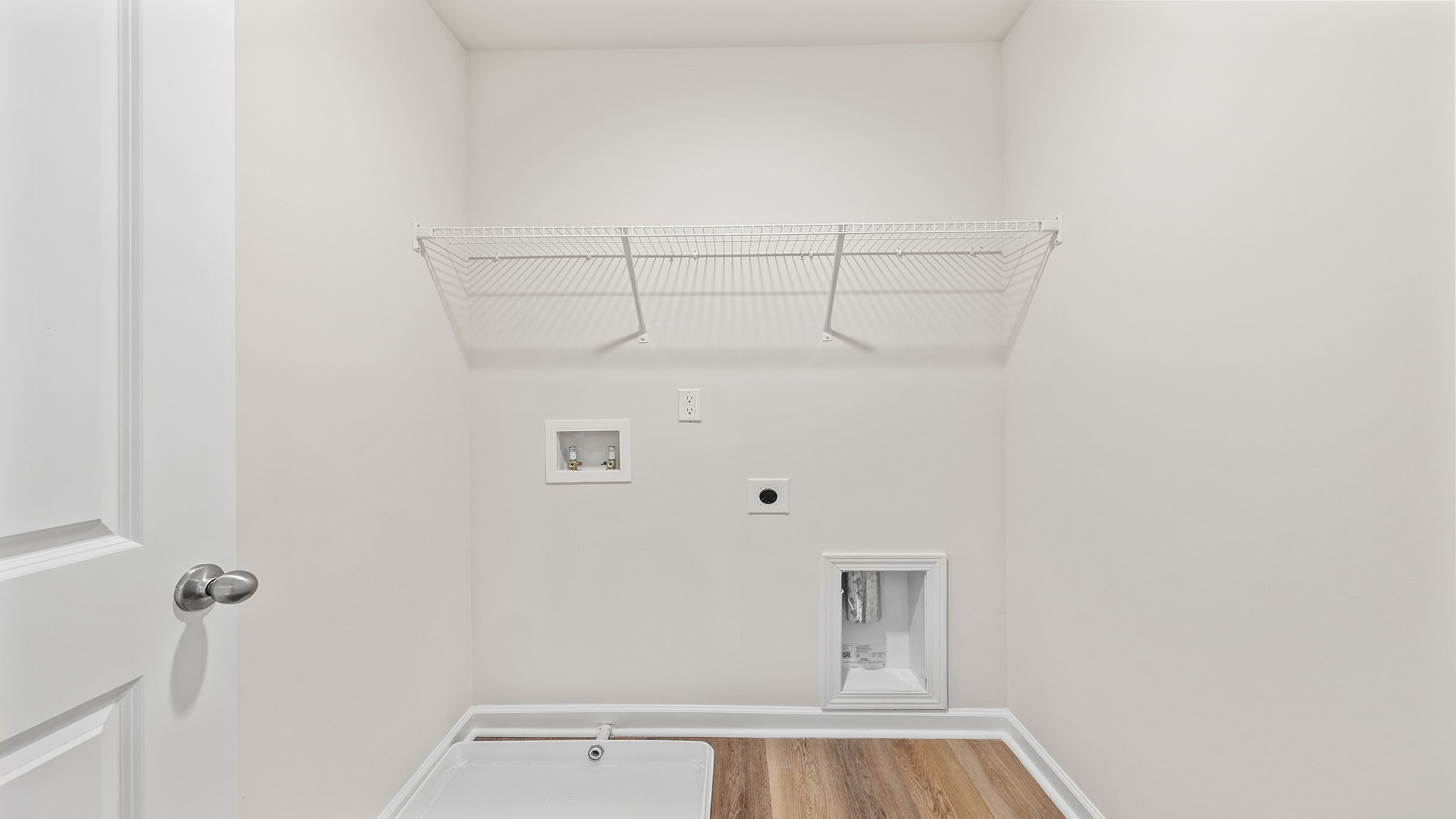 Walk-in laundry room with shelving.