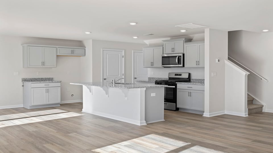 Open kitchen with quartz countertops and island.