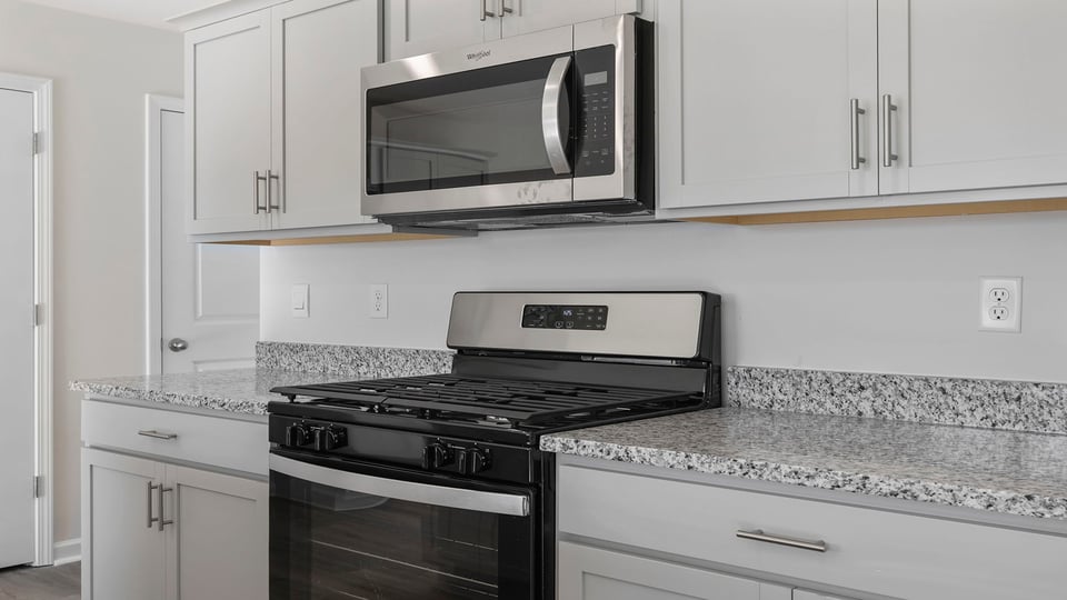 Kitchen features stainless steel appliances.