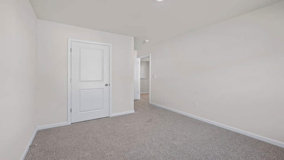 Bedroom with carpet and window.