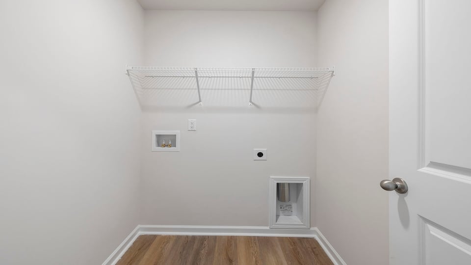 Walk-in laundry room with shelving.