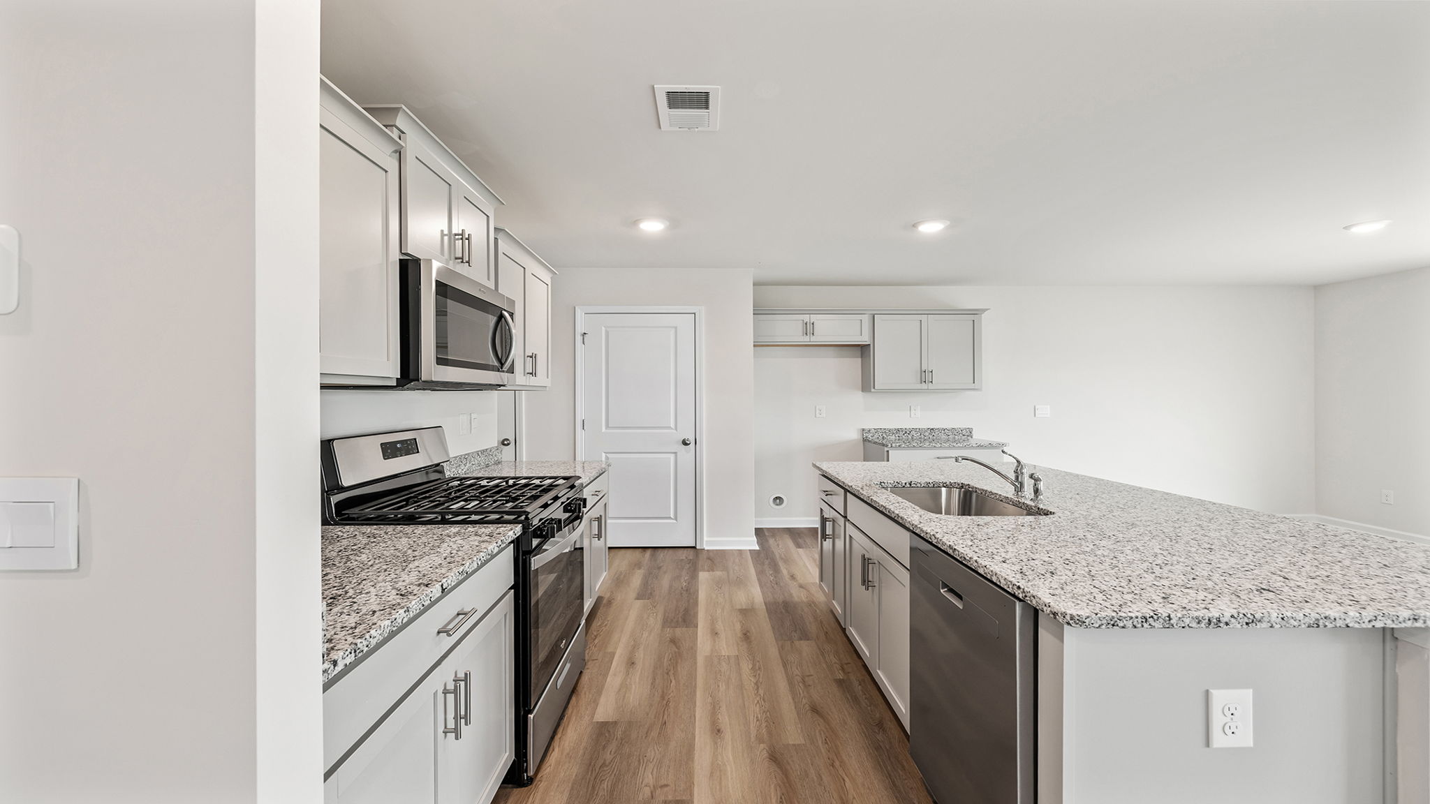 Kitchen with island and quartz countertops.