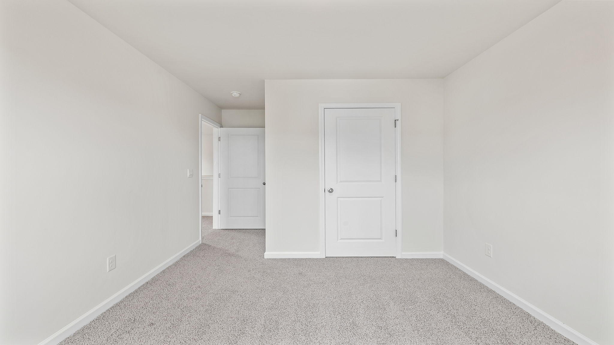 Bedroom with window and carpet.