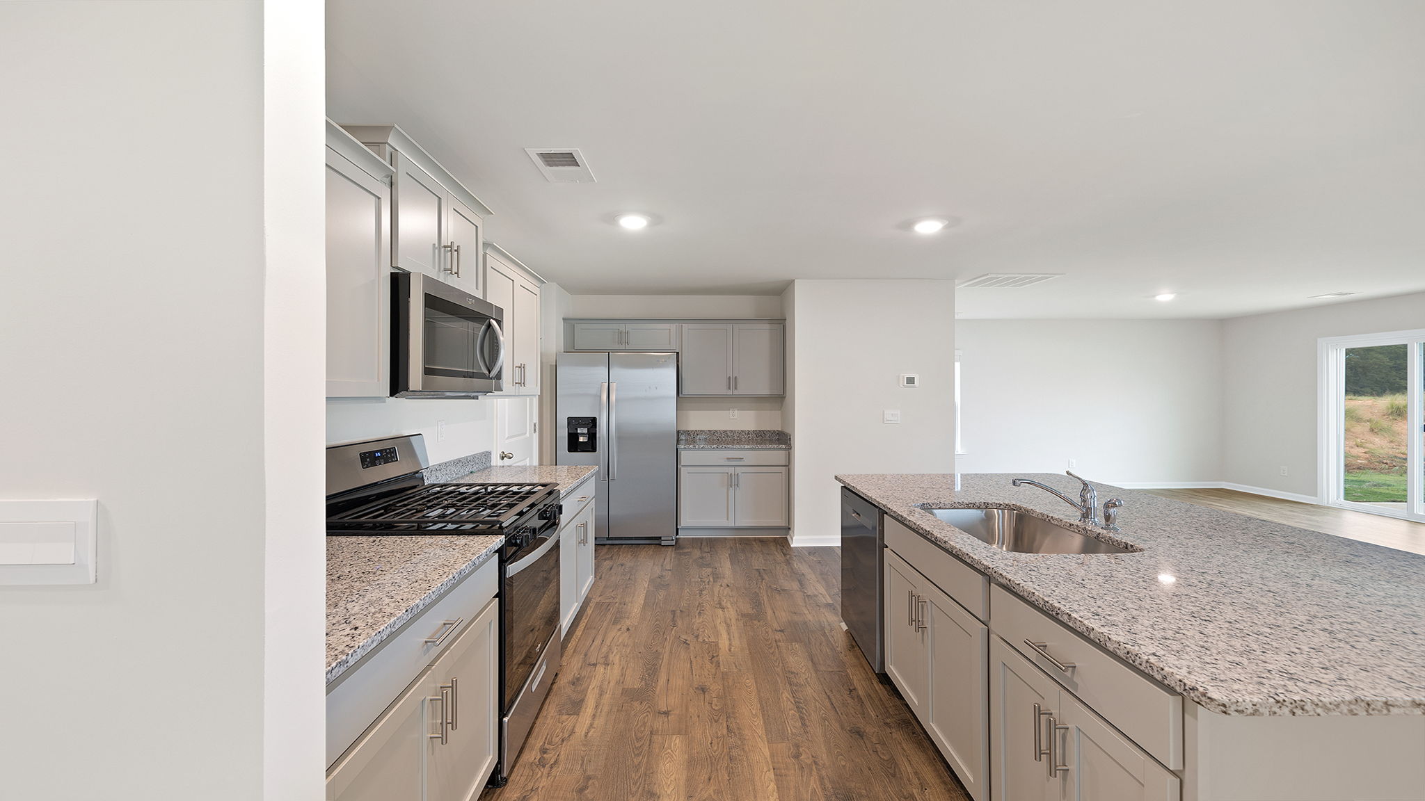 Kitchen with island and quartz countertops.