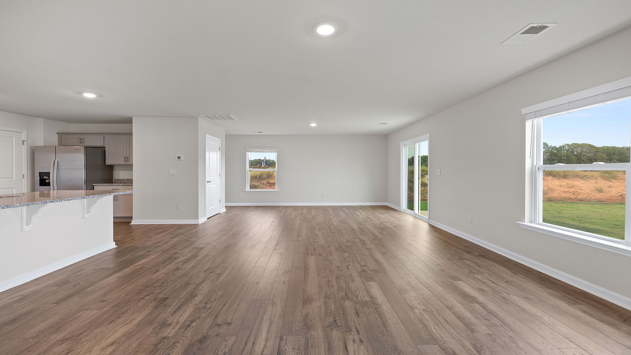 View from family room toward dining area with large window.